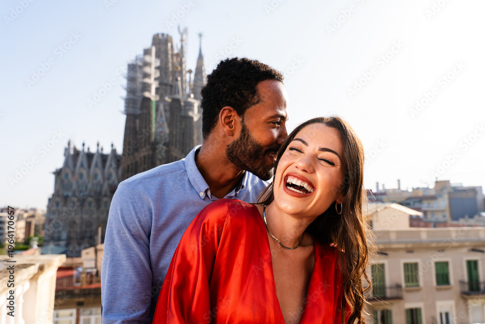 Obraz premium Multiracial beautiful happy couple of lovers dating in Barcelona on a rooftop with amazing city view