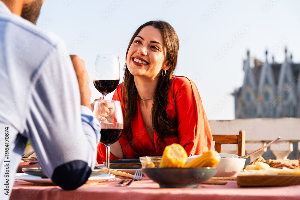 Obraz premium Multiracial beautiful happy couple of lovers dating in Barcelona on a rooftop with amazing city view