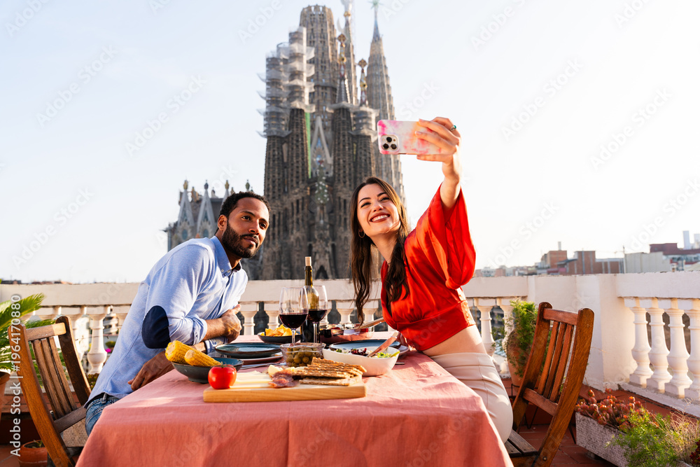 Obraz premium Multiracial beautiful happy couple of lovers dating in Barcelona on a rooftop with amazing city view