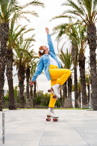 Beautiful red haired young woman with rollerskates having fun outdoors