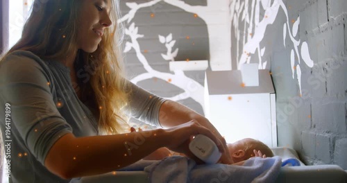 Mom reaching with bottle for health using lotion and rubbing baby's chest, orange sparks appearing
