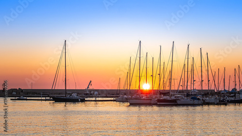 Tableau sur toile Sailboats docked in Sciacca harbor at sunset