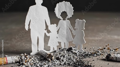 Silhouette family cutout with cigarette butts on the ground