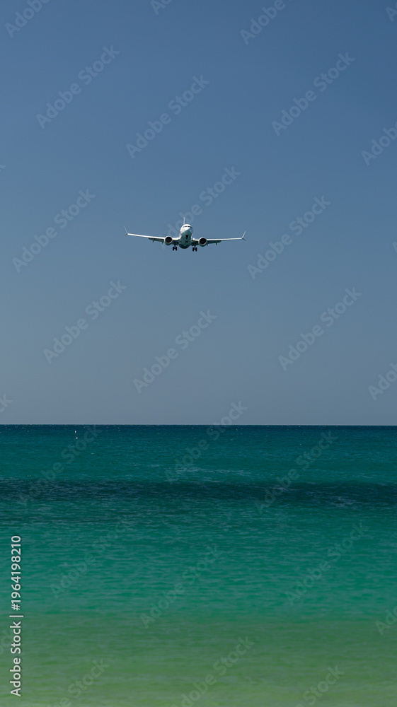 Fototapeta premium The plane is landing over the sea