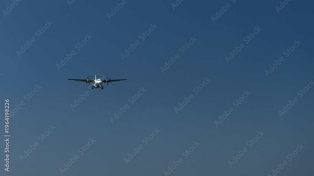 Fototapeta premium The plane is landing over the sea
