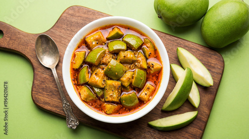 Obraz na plátne A bowl of spicy raw mango pickle or aam ka achar served with fresh green mangoes