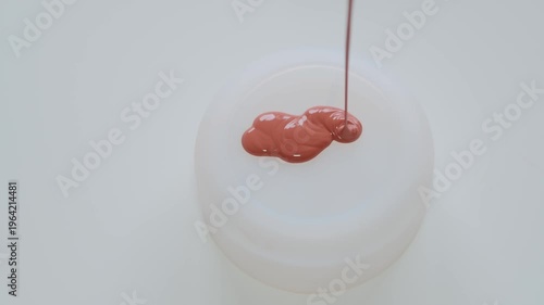 Red Paint Dripping Onto White Jar Lid Close-Up Minimal Glossy Liquid Pour Texture