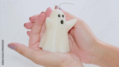 Female Hands Holding Cute White Ghost Candle For Halloween Decor And Seasonal Home Decoration
