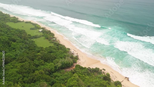 4K drone footage of Uluwatu, Bali: dramatic cliffs, crashing waves and turquoise ocean under bright daylight. Perfect for travel, nature, adventure and tropical destination projects
