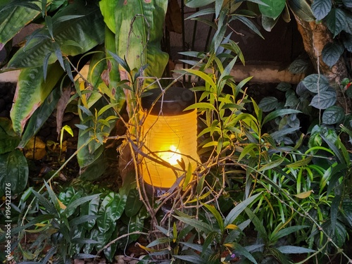 lantern with yellow light in the garden