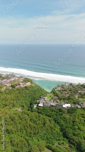 4K drone footage of Uluwatu, Bali: dramatic cliffs, crashing waves and turquoise ocean under bright daylight. Perfect for travel, nature, adventure and tropical destination projects