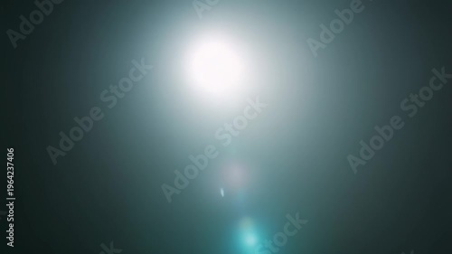 Abstract bright light expanding from a soft source, creating a glowing lens flare effect and an ethereal beam on a dark black background, ideal for overlay or a naturalistic overlay