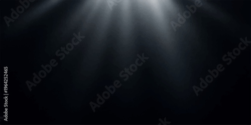 A brushed silver metal plate with a metallic steel texture acts as an empty stage backdrop under a bright spotlight against a dark grey wall