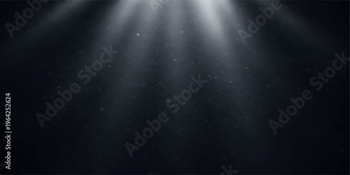 A spotlight on the stage reveals a brushed aluminum surface with a dark metallic texture and silver smoke patterns against a shiny black steel wall