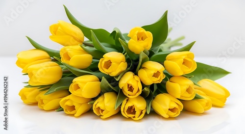 A beautifully arranged bouquet of vibrant yellow tulips showcasing their delicate petals and fresh green leaves