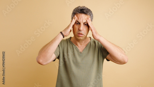 Slika na platnu Middle aged man feeling intense head pain, rubbing temples and frowning, sufferi