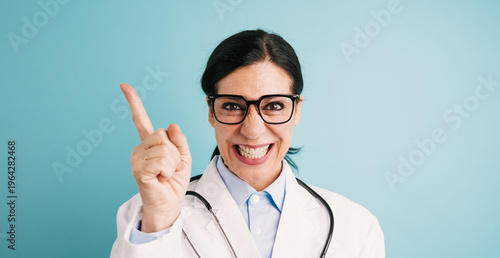 Quadro su tela Female doctor wearing a lab coat and stethoscope, making a stern or angry face w