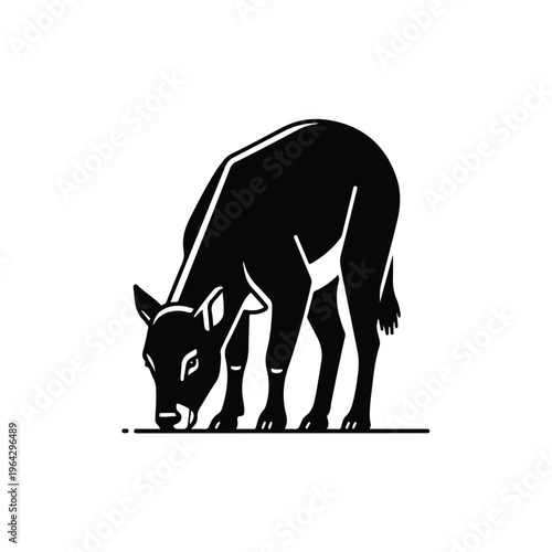 Black silhouette of a cow grazing on a plain surface