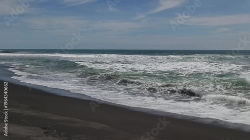 Sunny Day at South Coast Beach Indonesia with Blue Ocean Waves and Clear Sky