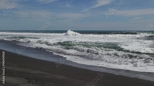 Sunny Day at South Coast Beach Indonesia with Blue Ocean Waves and Clear Sky