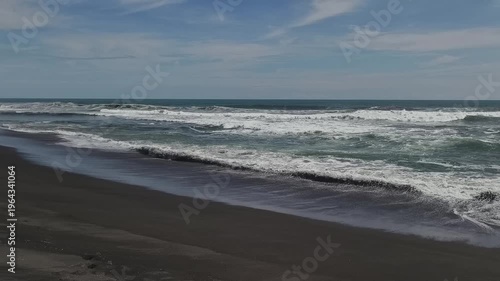 Sunny Day at South Coast Beach Indonesia with Blue Ocean Waves and Clear Sky