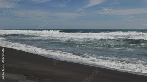 Sunny Day at South Coast Beach Indonesia with Blue Ocean Waves and Clear Sky