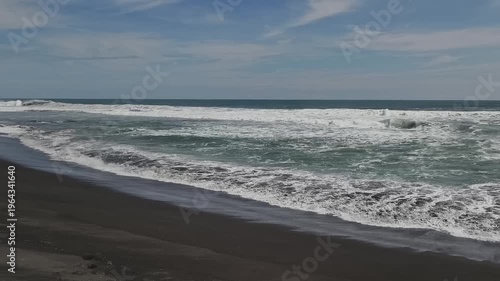 Sunny Day at South Coast Beach Indonesia with Blue Ocean Waves and Clear Sky
