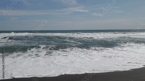 Sunny Day at South Coast Beach Indonesia with Blue Ocean Waves and Clear Sky