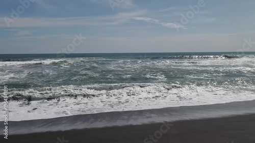 Sunny Day at South Coast Beach Indonesia with Blue Ocean Waves and Clear Sky