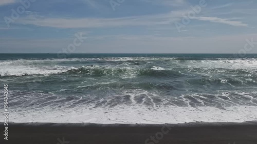 Sunny Day at South Coast Beach Indonesia with Blue Ocean Waves and Clear Sky