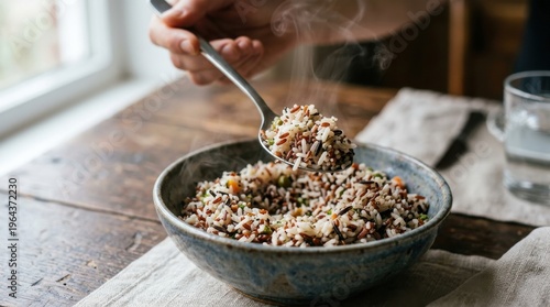 Person enjoying a healthy quinoa salad in rustic kitchen setting