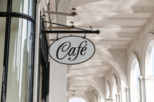 HAMBURG, GERMANY - MARCH 07, 2026: Vintage oval Cafe sign hanging under the historic Alsterarkaden white arches in downtown Hamburg near Rathausmarkt