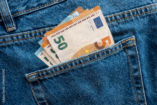 Pocket in jeans with money, much bills. Business concept.