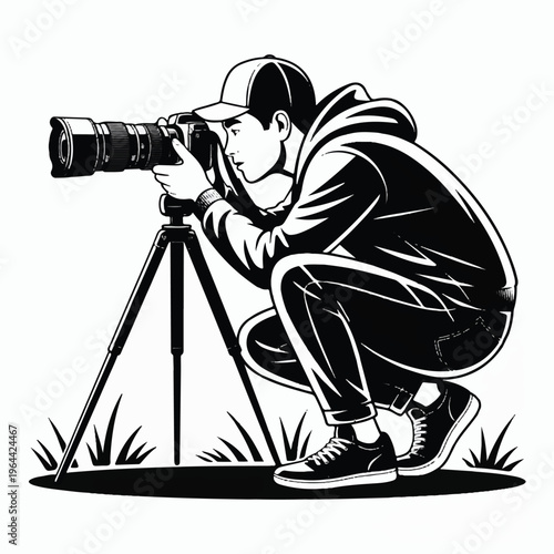 A black and white illustration of a photographer in a crouching position taking a photograph with a professional camera mounted on a tripod.  