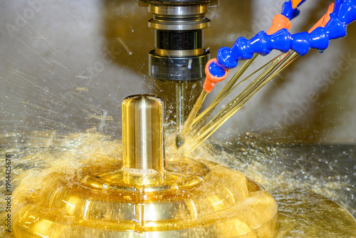 Precision finish cut on brass parts using a ball nose end mill with an oil coolant system on a CNC milling machine.