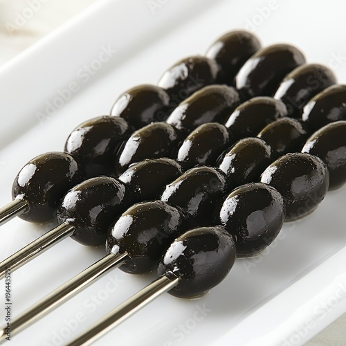 A platter of glossy black olives on skewers invites everyone to enjoy