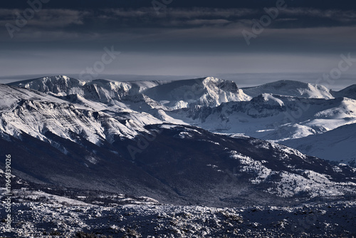 Winter twilight lanscape from Patagonia moutains with snow. Lago Nordenskjold, Torres del Paine National Park, Chile. Pink blue evening sky. Traveling in Chile,  hills.