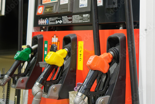 Fotografie Gas station fuel nozzles for regular, high-octane and diesel in Japan, concept o