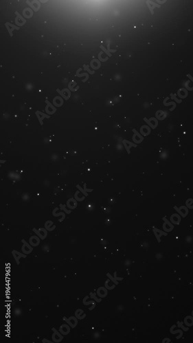 Vertical silver white glowing particles rising on black background with soft top light flare, 9:16 smartphone video, Full HD