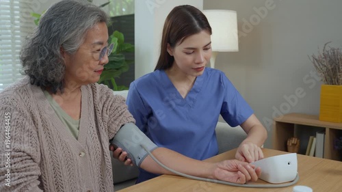 Caregiver elderly home care and nurse blood pressure monitoring healthcare support and wellness, gentle check in bright living room, senior woman with cuff, calm guidance compassion comfort at home