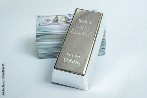 Fine silver and pile money banknote 100 USD on a gray background