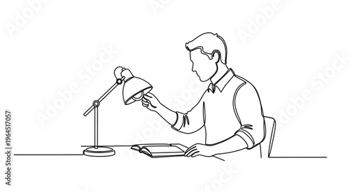 Man adjusting desk lamp while reading book at study table  