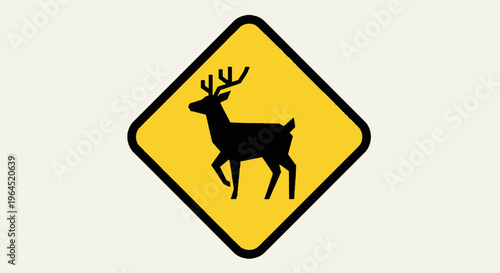A yellow diamond road sign displaying a black deer silhouette, indicating animal crossing