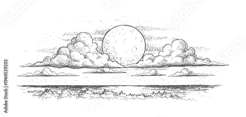 Full moon rising above clouds over grassy landscape