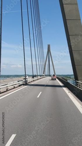 Vertical wide shot from a vehicle driving across the Oresund Bridge connecting Denmark and Sweden. Transportation, logistics and travel concept on a famous cable-stayed bridge