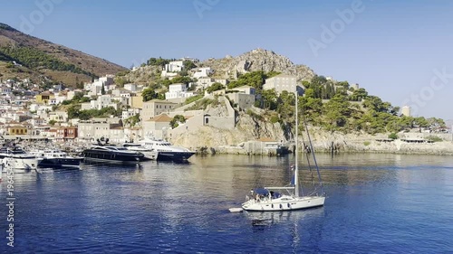 A sailing ship is leaving the port of Hydra in Greece.