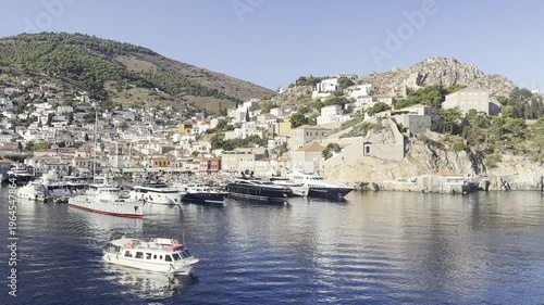 A ship is leaving the port of Hydra in Greece.