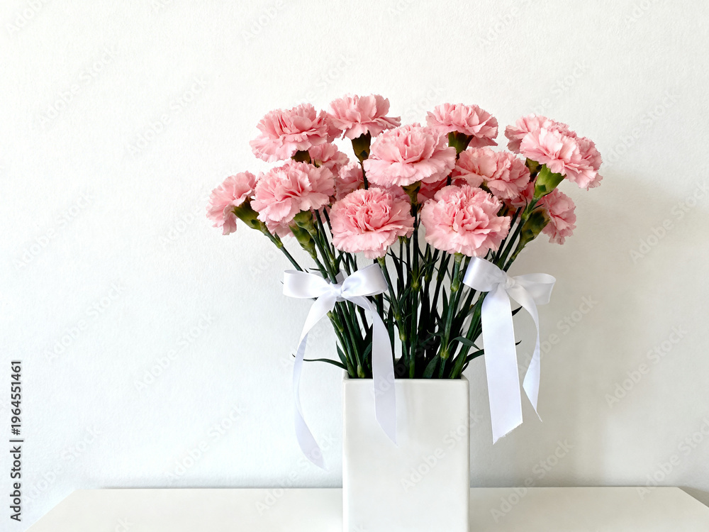 Fototapeta premium Carnation flower arrangement in minimalist natural light with copy space, celebration and mother's day concept