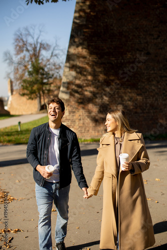 Couple walks hand in hand w...