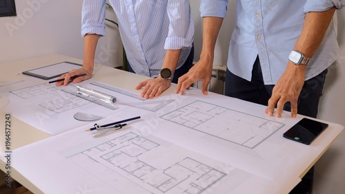 Fotografie Experienced architects collaborating on new building layout, reviewing blueprint